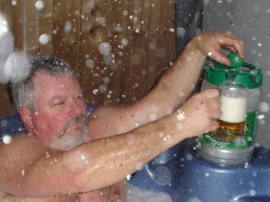 Pat pouring a beer in a hot tub in winter