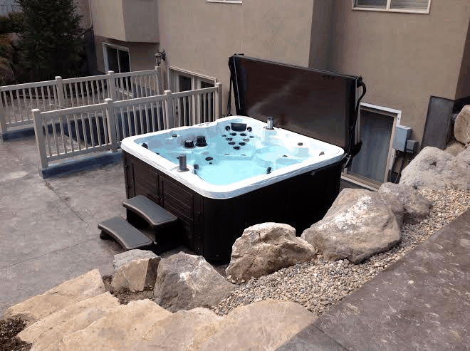 arctic spas hot tub next to a house