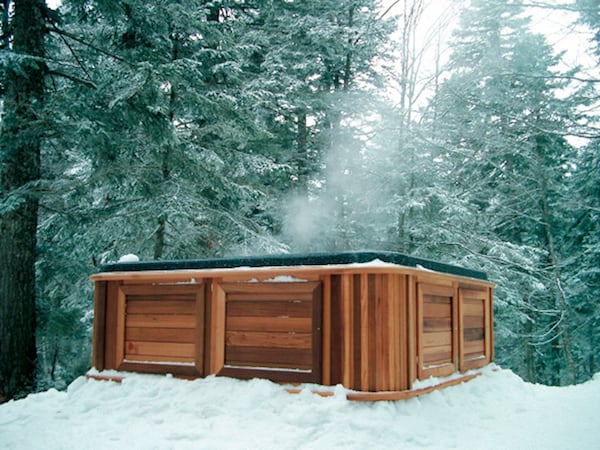 A hot tub in a snow forest